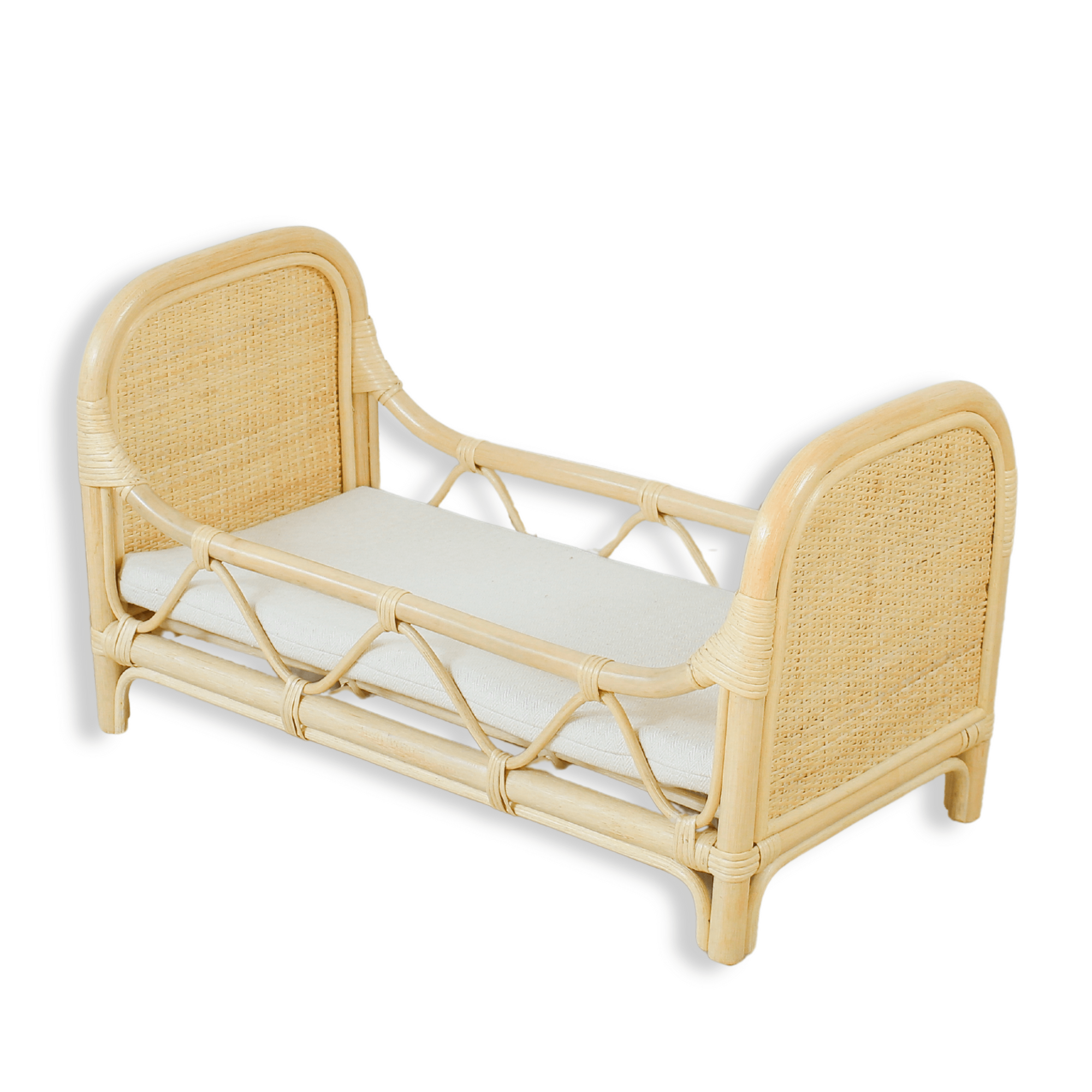 Wicker bed with a white mattress on a white background