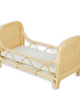 Wicker bed with a white mattress on a white background