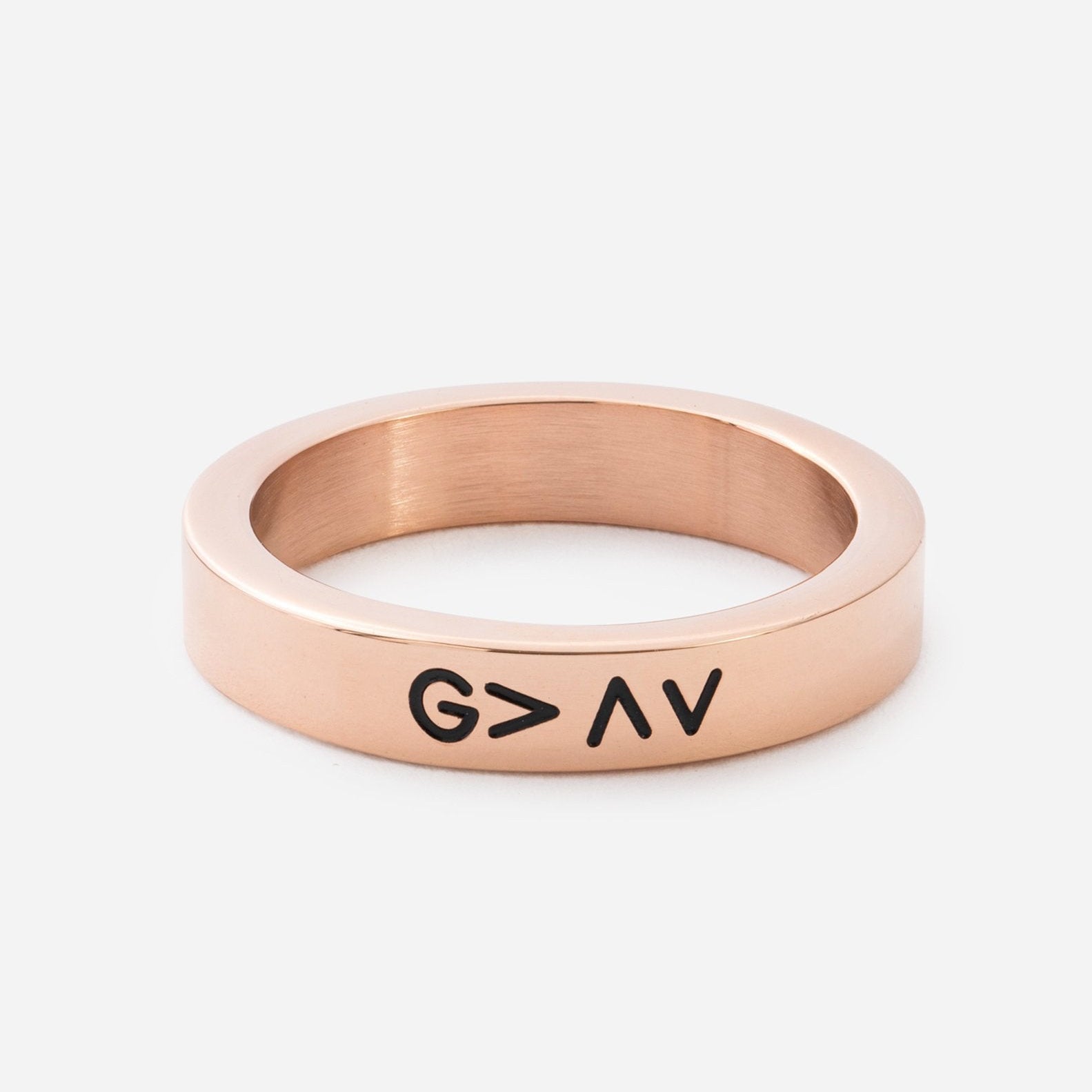 Rose gold ring with 'G > A' engraving on a white background