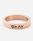Rose gold ring with 'G > A' engraving on a white background