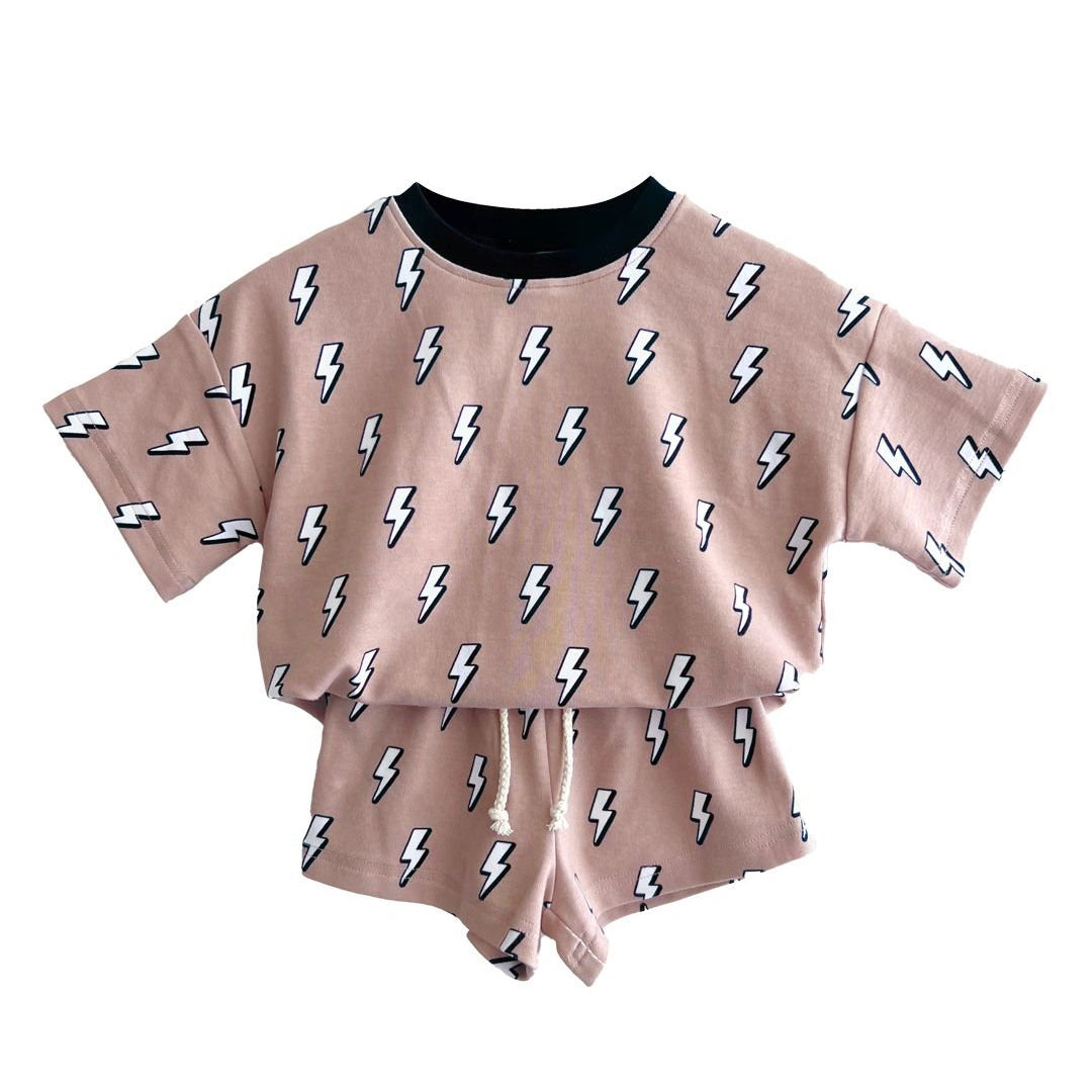 Two-piece outfit with a top and shorts featuring lightning bolt patterns on a beige background.