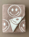 Towel with smiley face patterns on a brown background