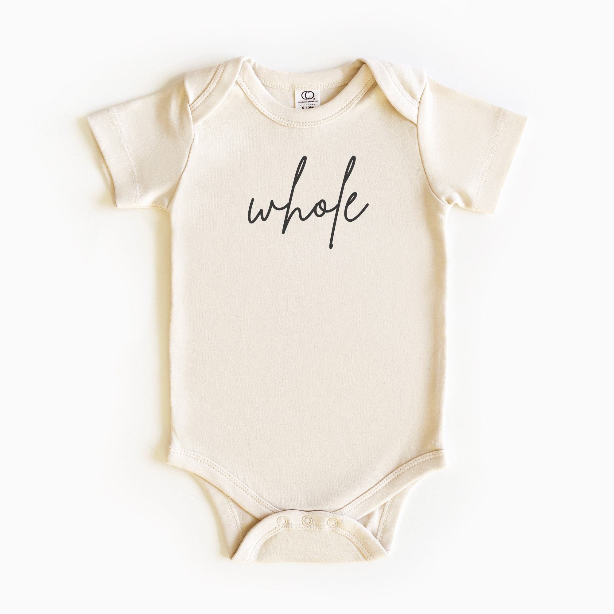 Baby wearing “Whole” affirmation bodysuit – Christian script design organic cotton outfit by Lumiere Vive